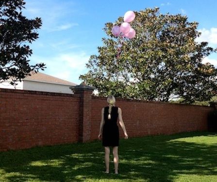 five pink balloons being let go