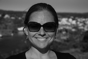 black and white photo of Bivens's face. she's smiling and wearing sunglasses