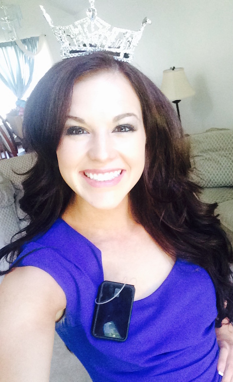 A selfie of Miss Idaho 2014 Sierra Sandison wearing a pageant crown. Her insulin pump is visible, attached to her purple dress.
