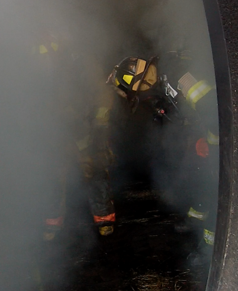 Two firefighters are depicted in full turnout gear, SCBA, and helmets bending over and holding their knees, visually exhibiting signs of exhaustion.
