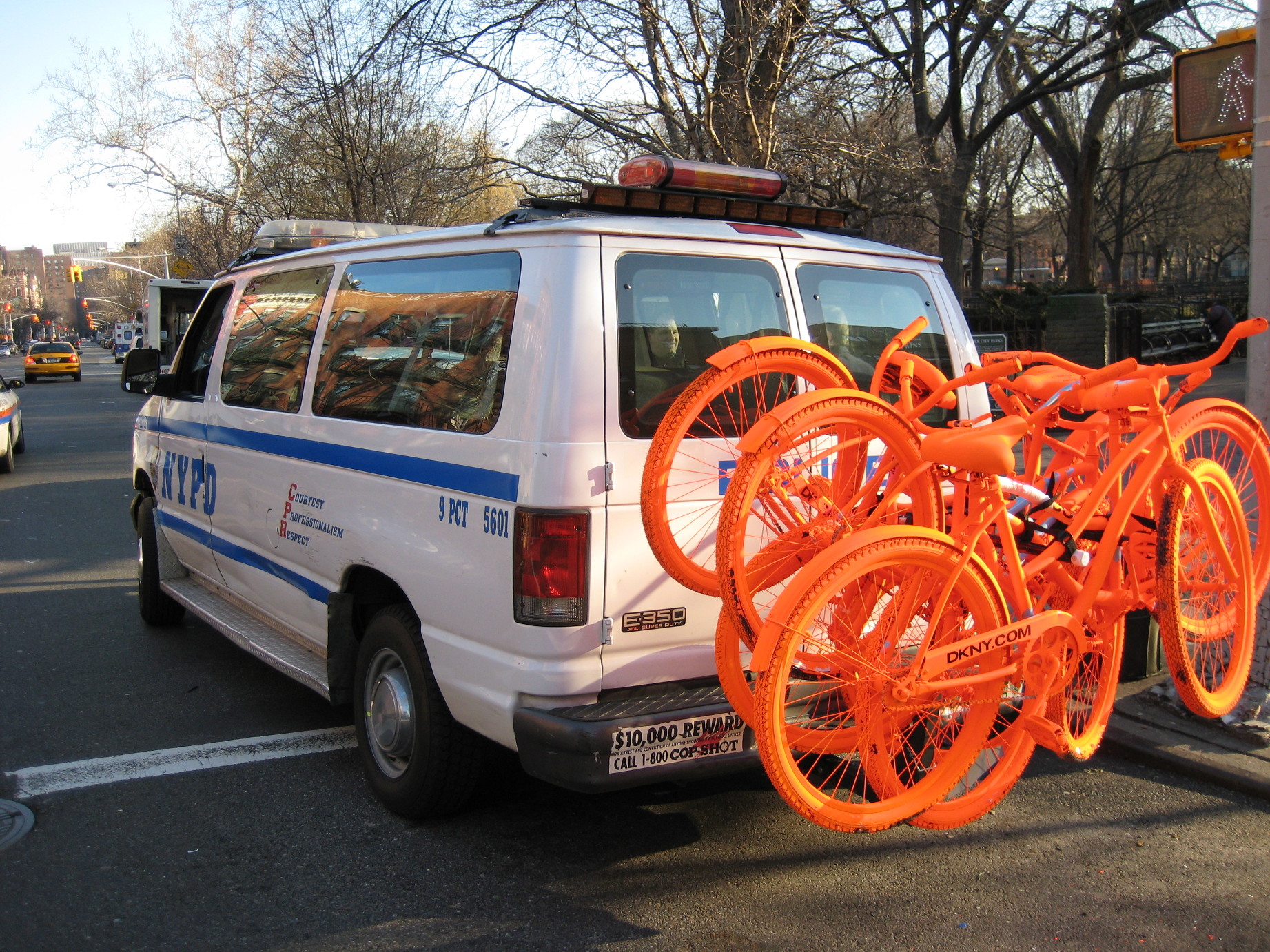 NYPD Van with five orange DKNY bikes on the back