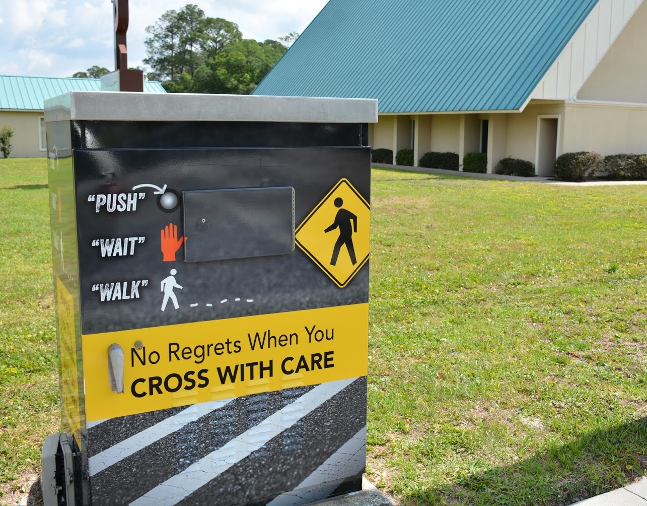 Public service poster instructs pedestrians in safe crossings and reads, 'no regrets when you cross with care'