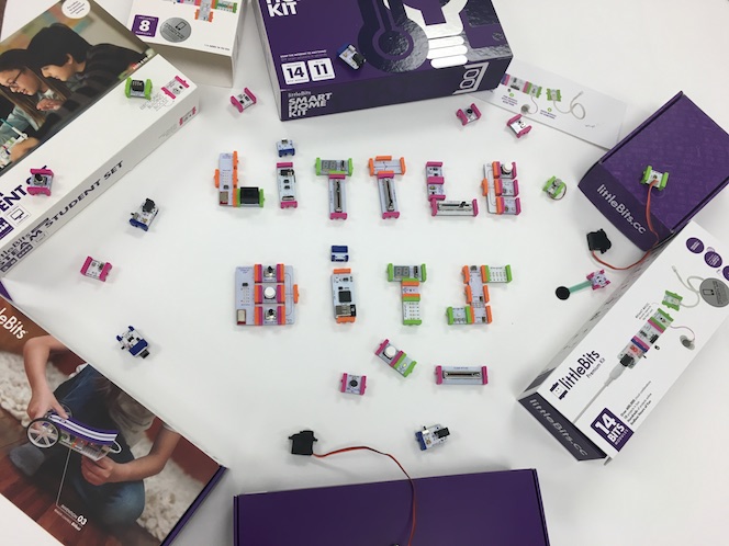 a bunch of littleBits sitting on a table to spell out the words LITTLE BITS