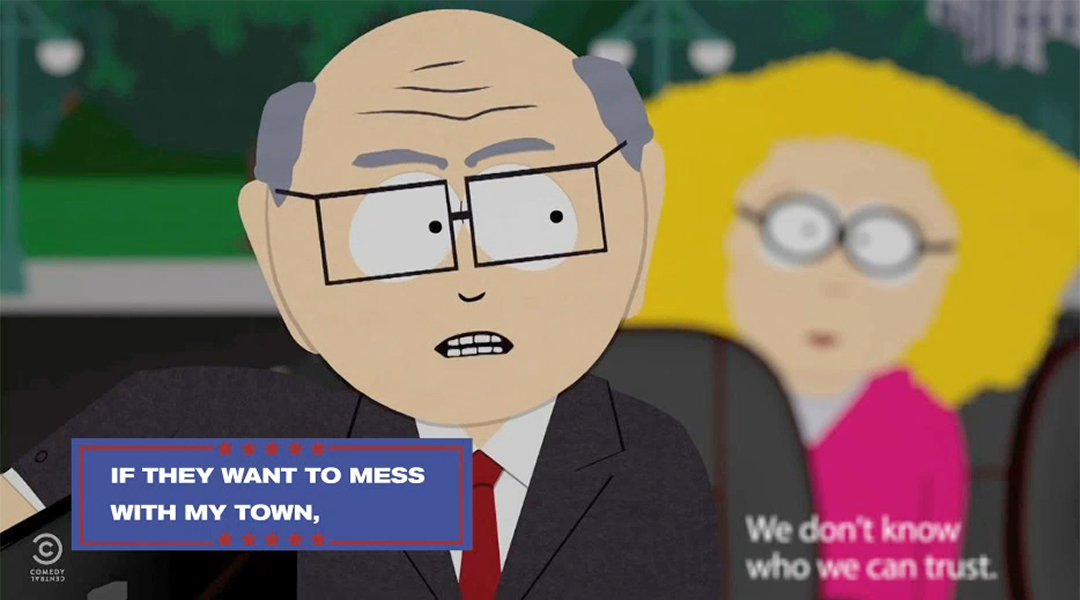 Mr. Garrison is sitting in front of Principal Victoria in this two shot from an episode of South Park