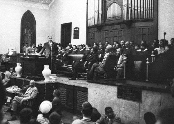 Martin Luther King giving the speech in the church; black and white