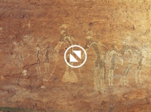 A rock painting with dancers