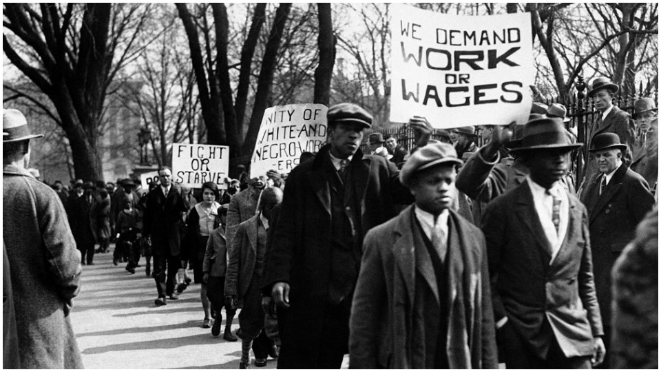 lines of protestors carrying signs demanding work for wages, black and white