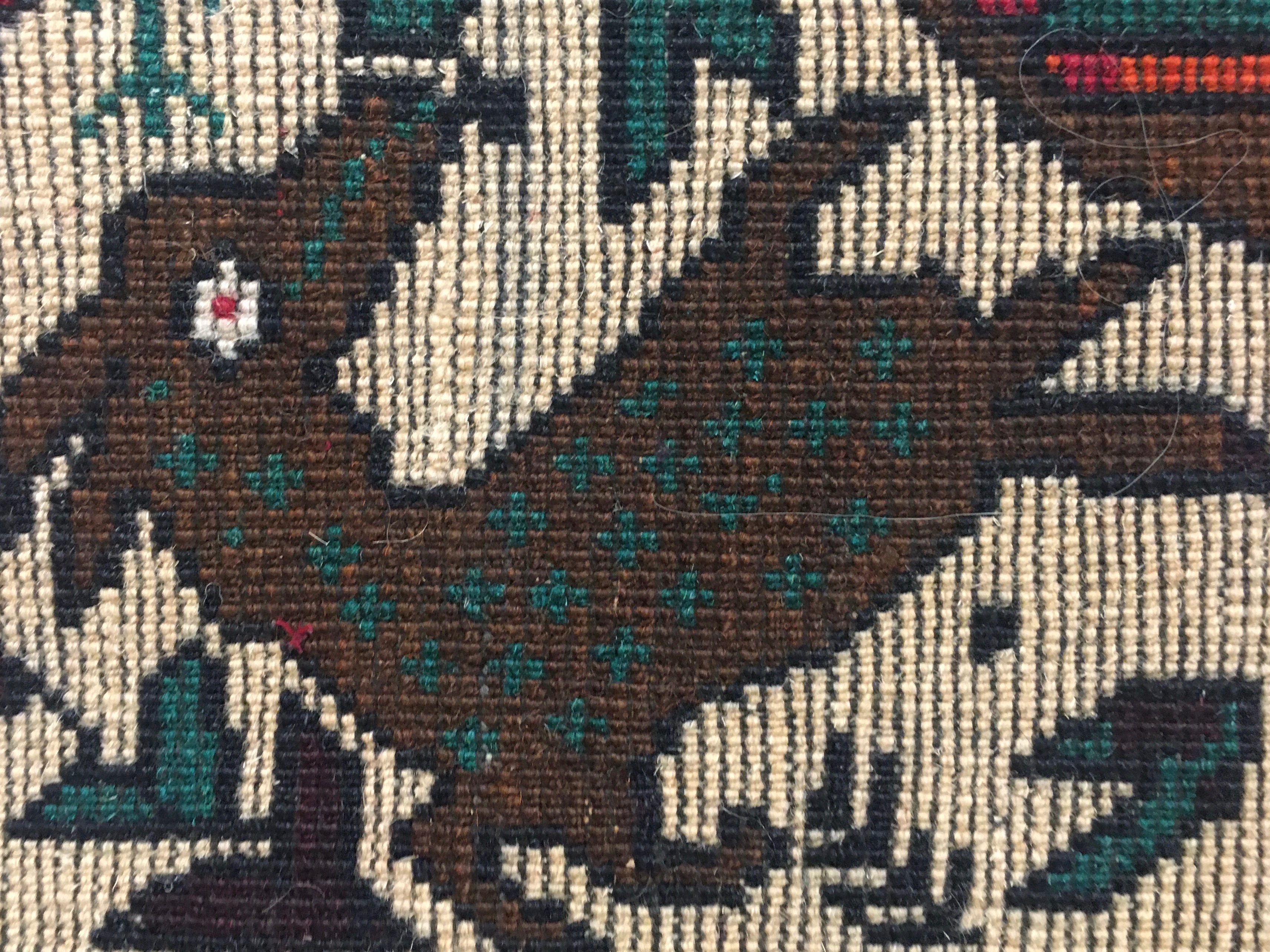 A detail of the of a deer shown from the back of the rug