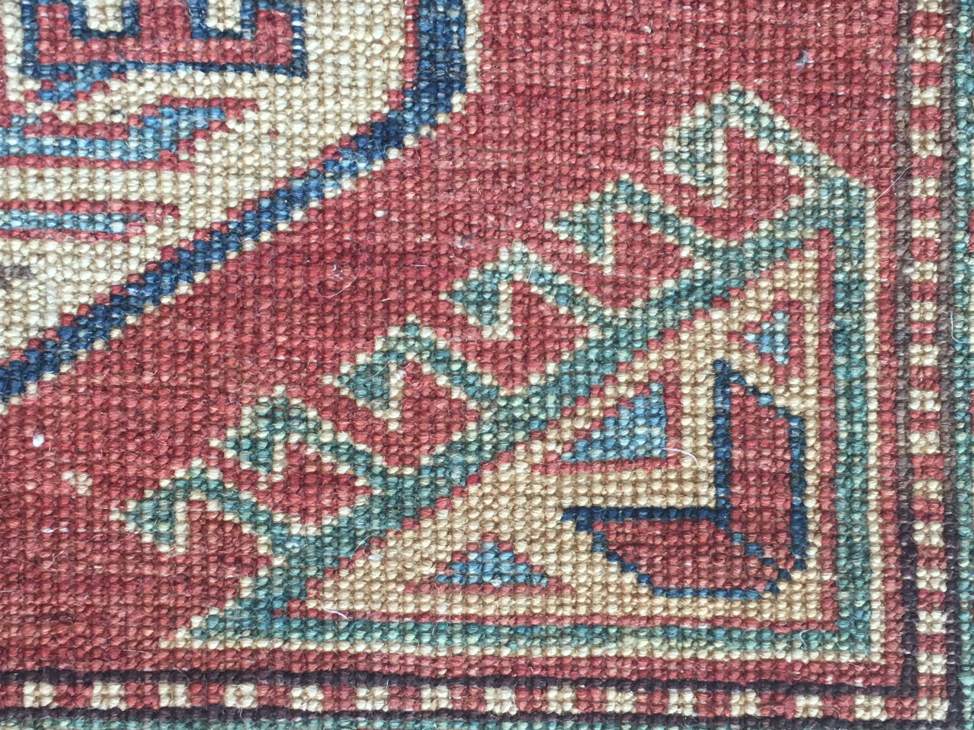 Detailed photo of corner rug knots from the back side showing intricate geometric patterns