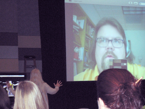 Teleconference at CCCC: Johndan's head on a large screen; the back of heads of audience members are shown