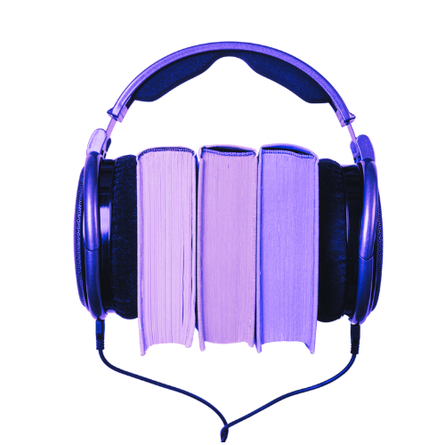 A purple set of headphone with three books in between the cushions.