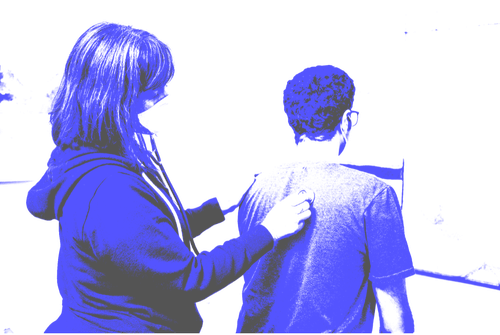 A doctor examines a patient.