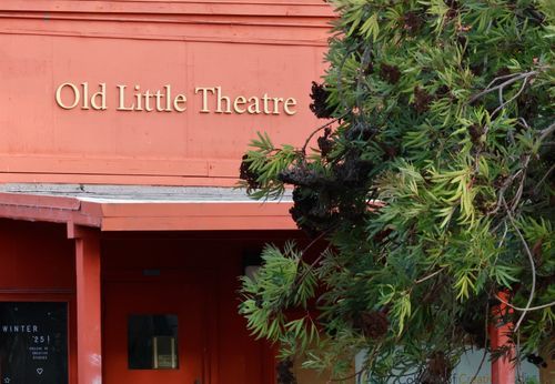 A shabby-chic campus theater made of wood with the words 'Old Little Theatre.'