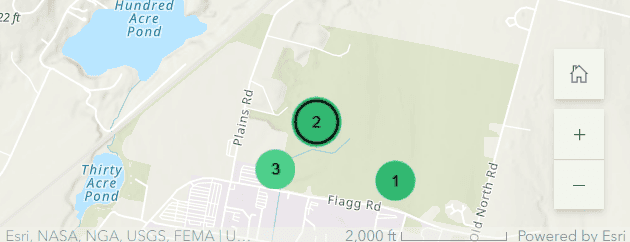 An Esri map image displaying a street view of the North Woods, with three numbered green circles on the map.