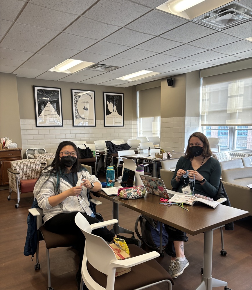 Hannah and Olivia crochet during a disability studies pedagogy training.