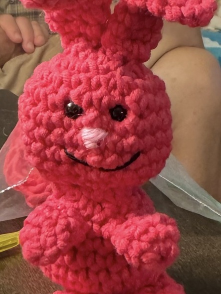 A pink crochet bunny named 'Evil Bunny' with a vaguely evil or devious expression.