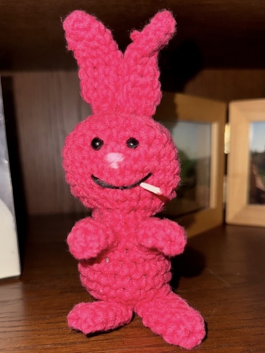 Evil Bunny looking significantly happier. A cigarette made from a toothpick sticks out of its mouth.