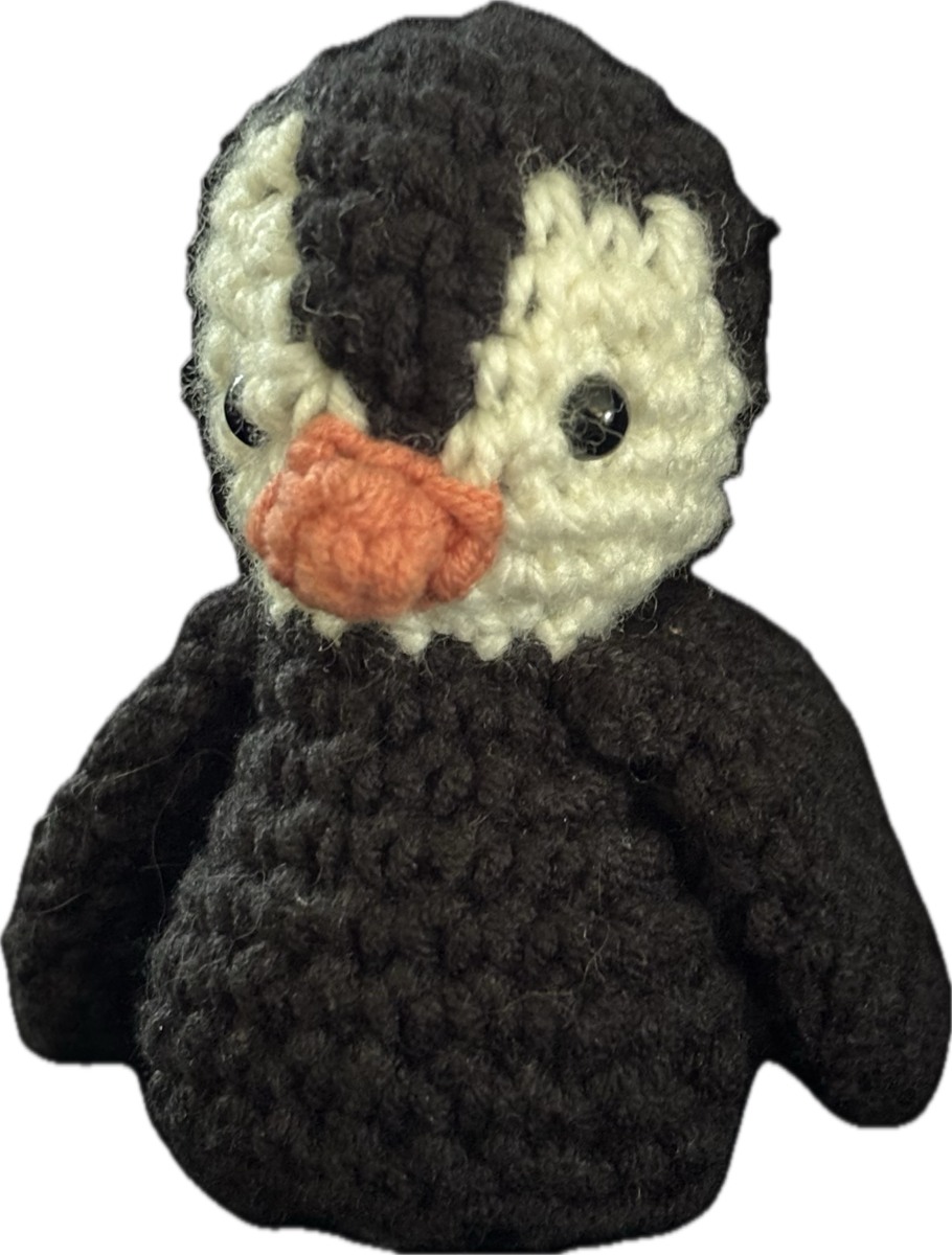 Metallic blue darning needle with bent tip.