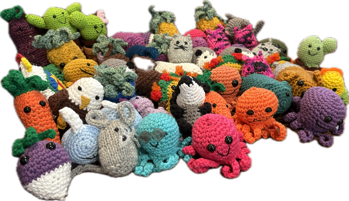 A green, blue, cream, and black-colored ball of yarn.